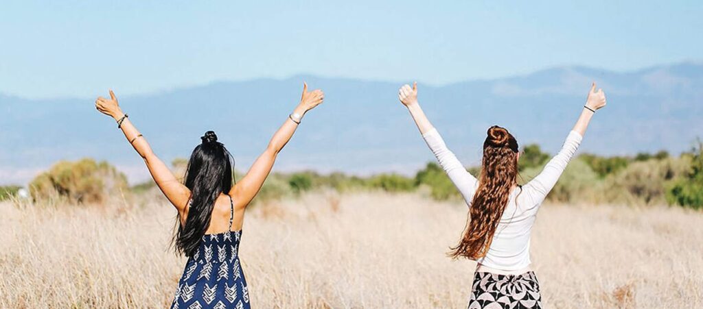 Women with their hands up selebrating